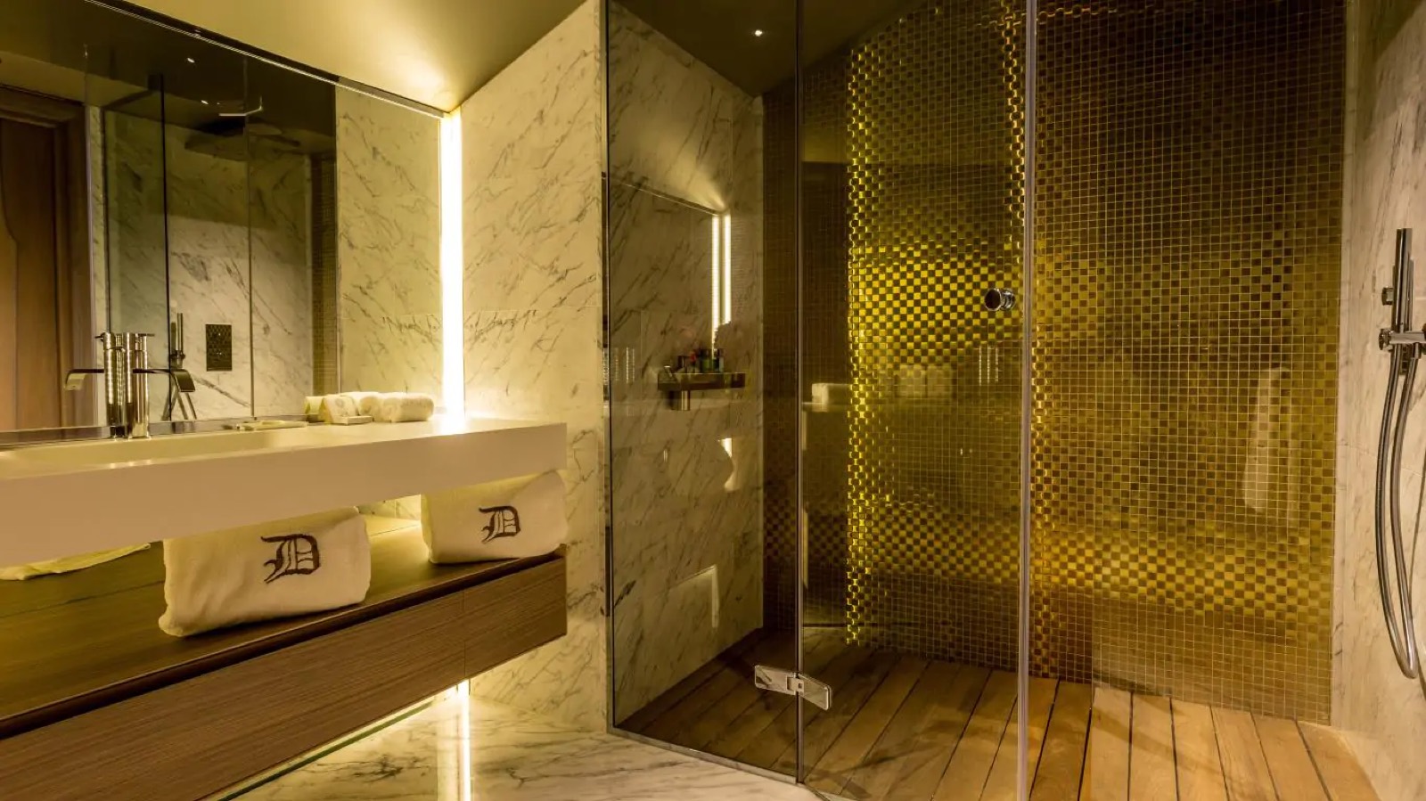 Marble bathroom with gold mosaic shower