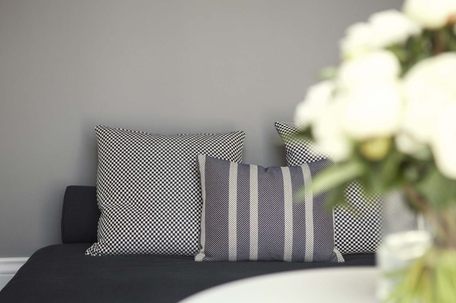 Checked and striped cushions on the daybed