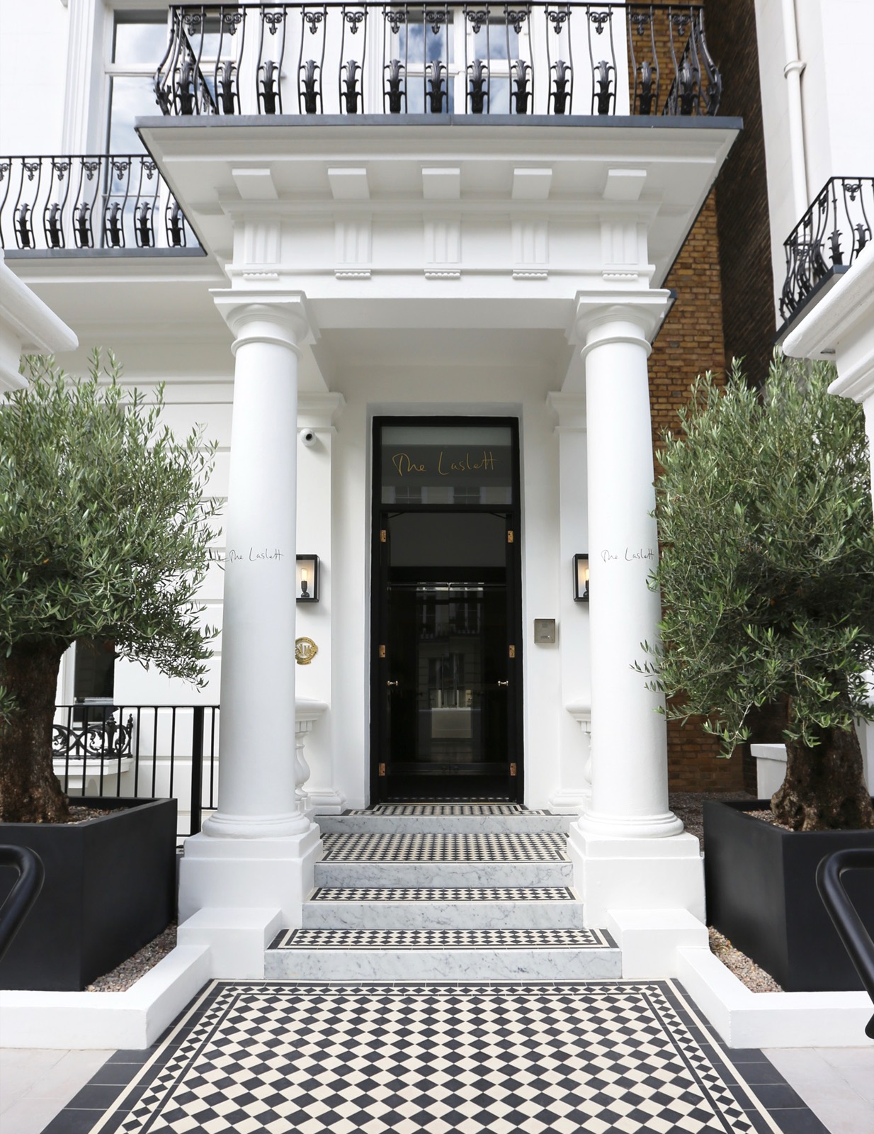 The pillared entrance with chequerboard tiled path