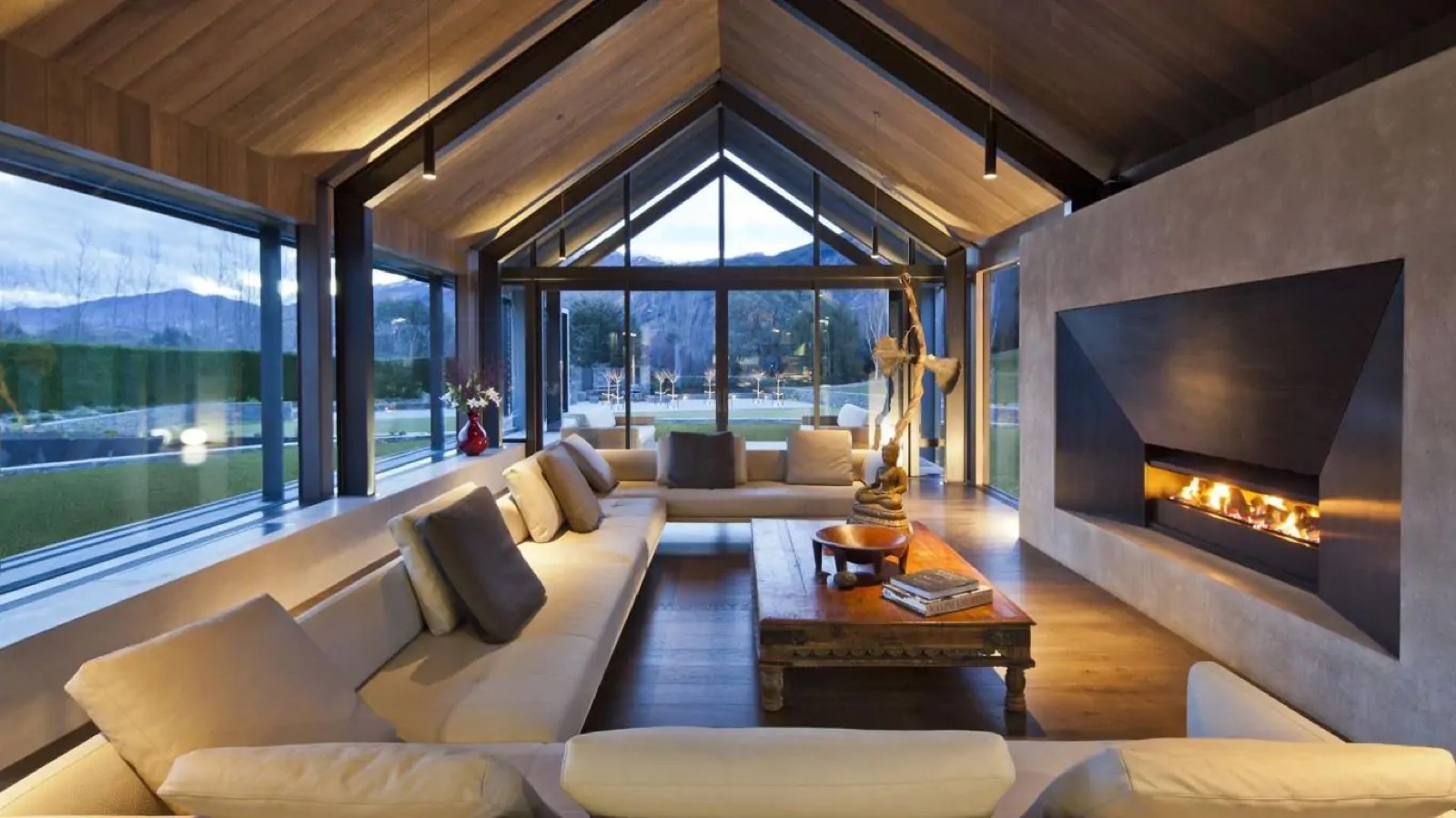Great room glazed to the mountains at dusk