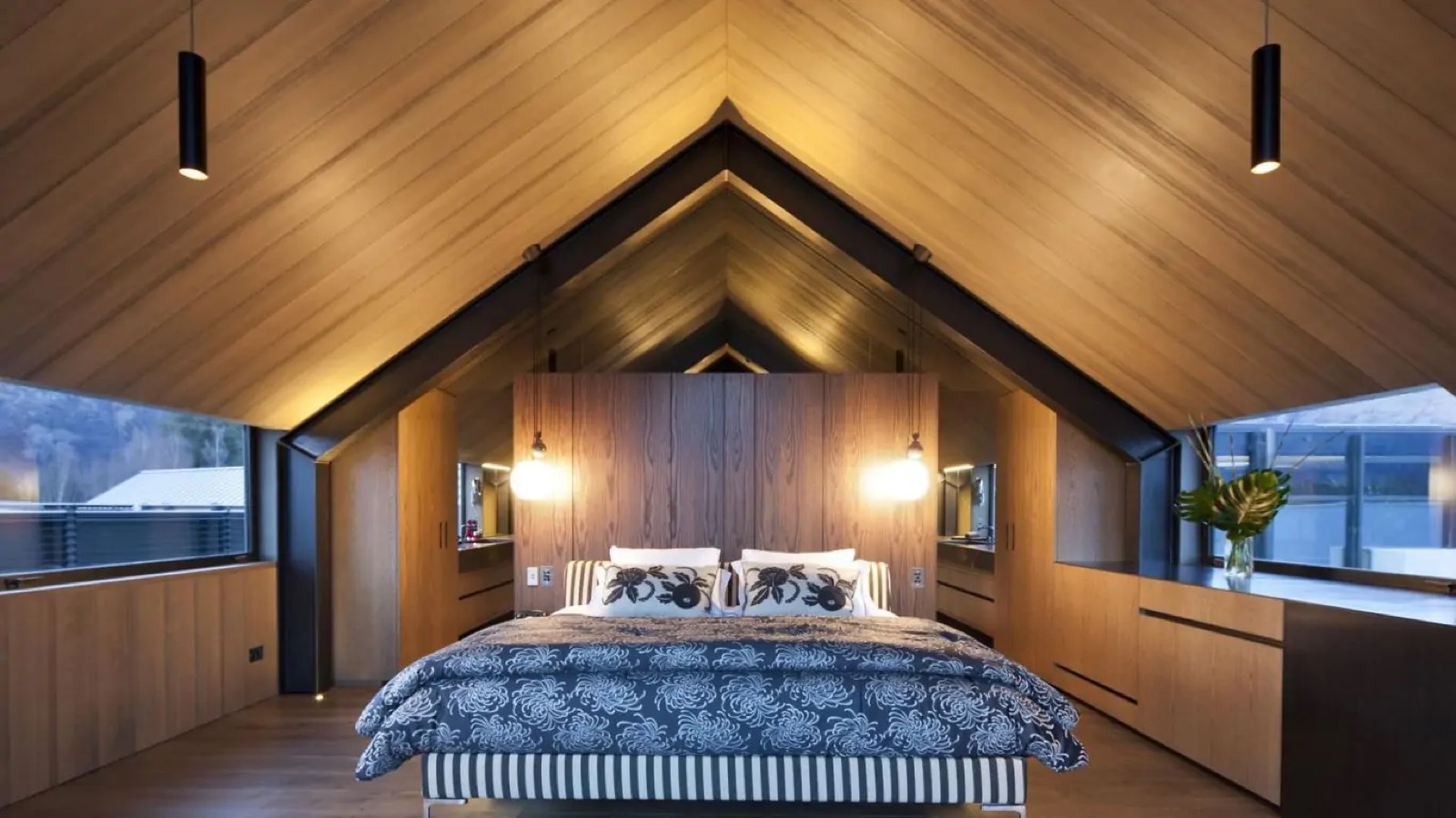Second bedroom with panelled headboard and dressing area