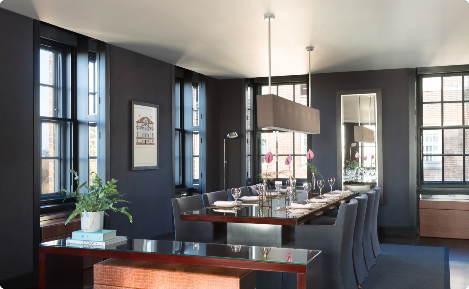 Dining room beneath a linear pendant light