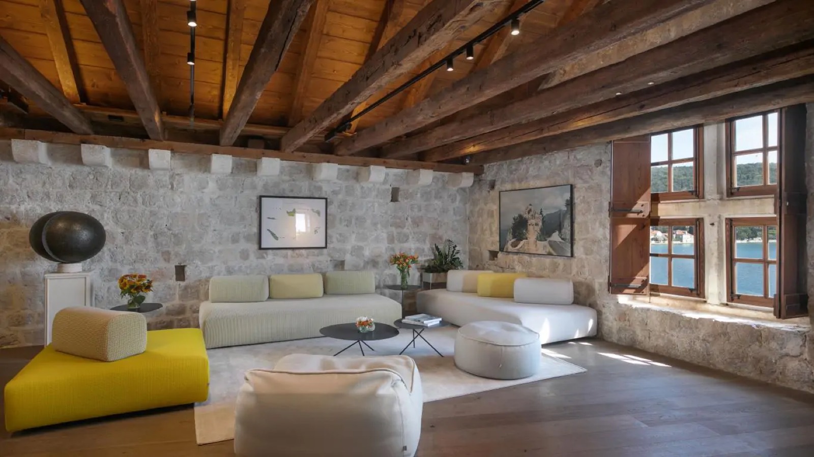 Sitting room with beamed ceiling and water views