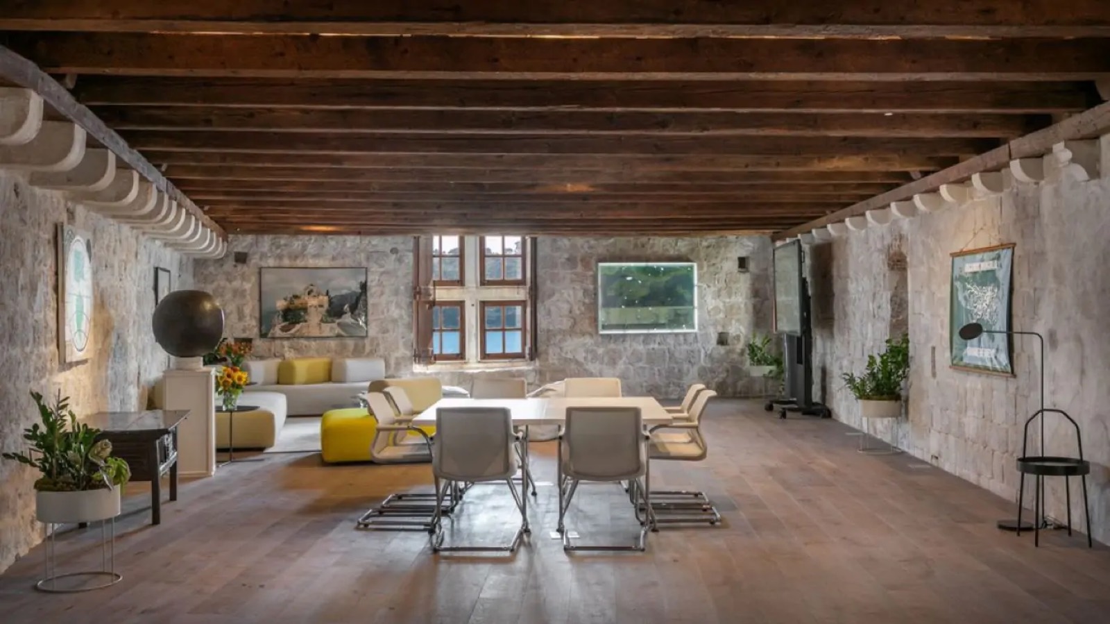Long beamed hall with table and seating