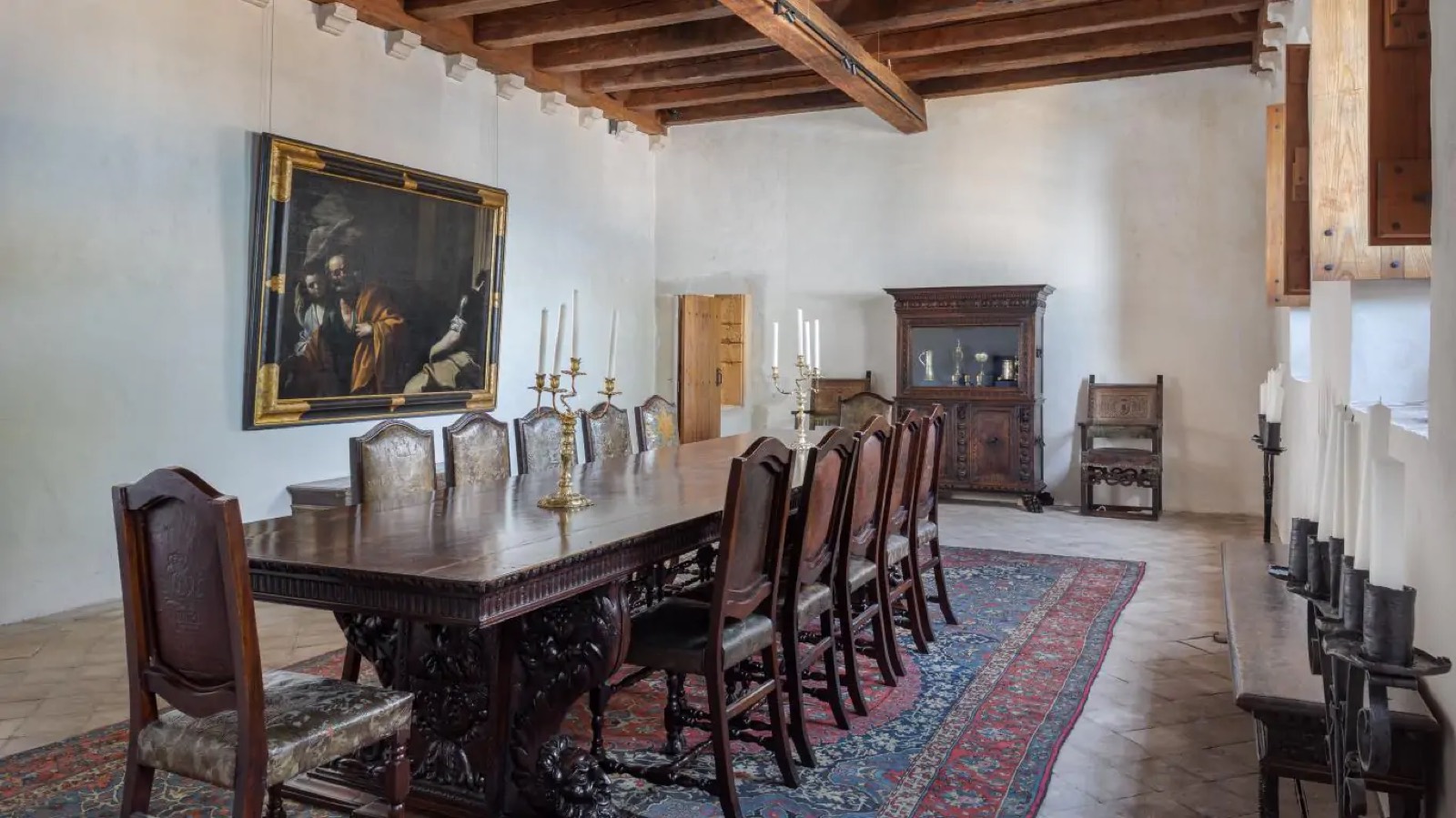 Formal dining room with Renaissance table and painting