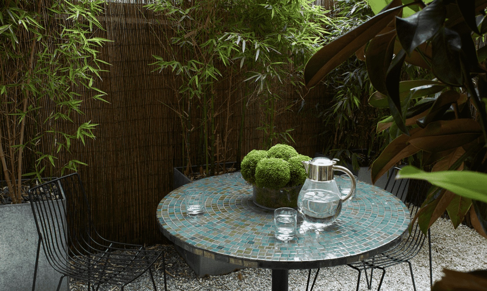 Planted patio with mosaic table and chairs