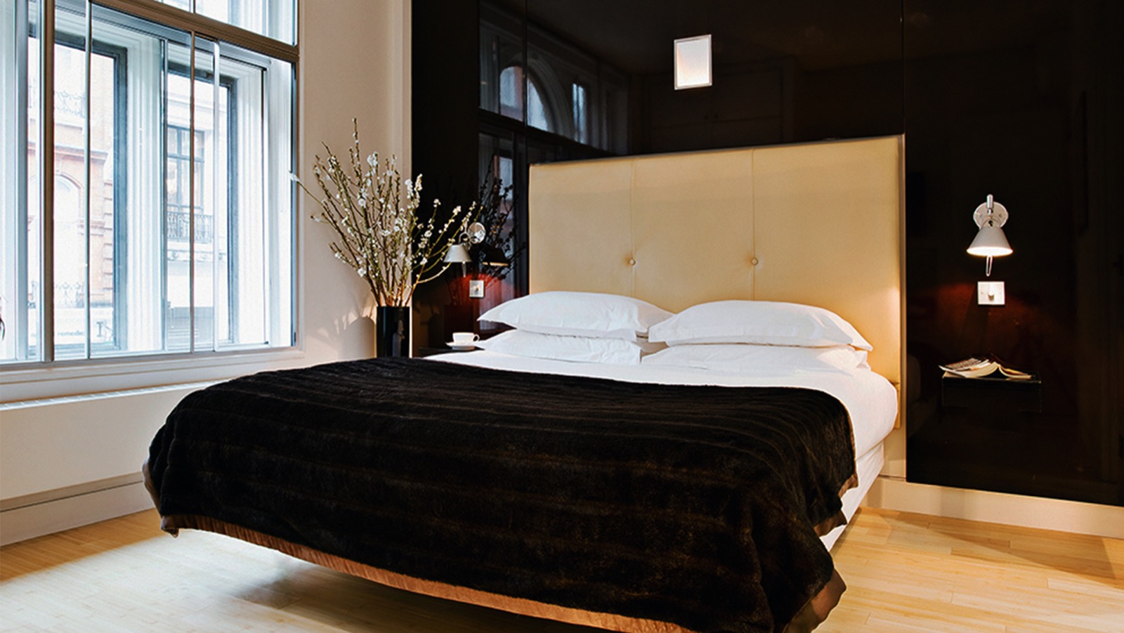 King bedroom with tall window over the street