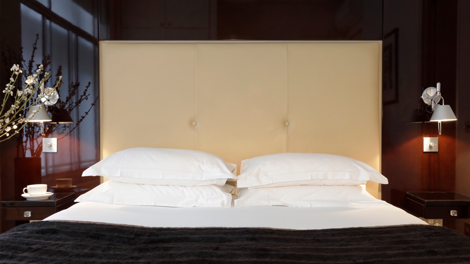 Cream padded headboard with chrome reading lights