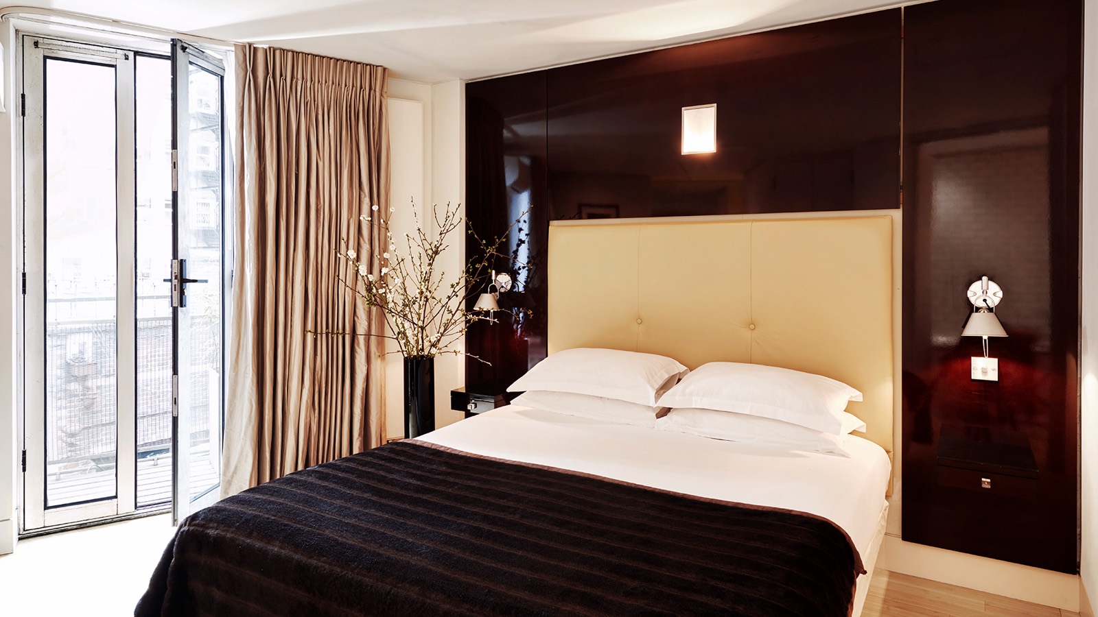 King bedroom with doors to the balcony