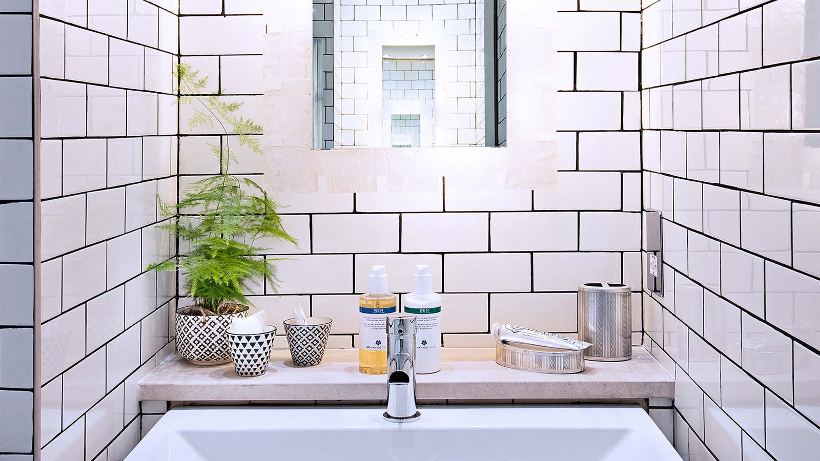 Bathroom tiled in white metro brick