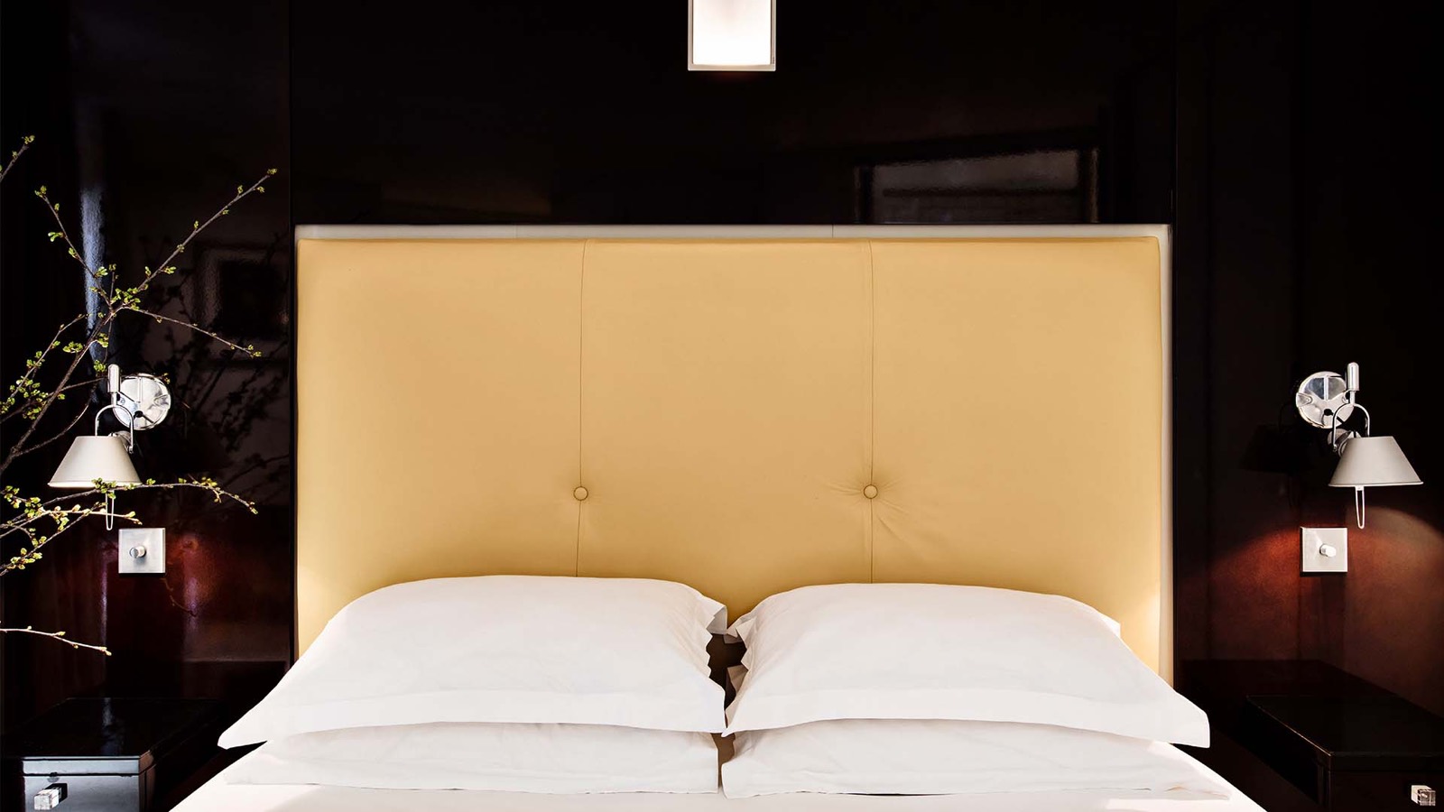 Bedroom with padded headboard and reading lights