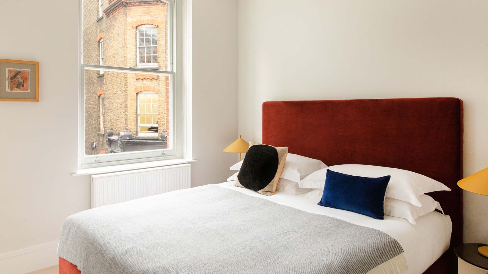 Red bedroom with tall sash window
