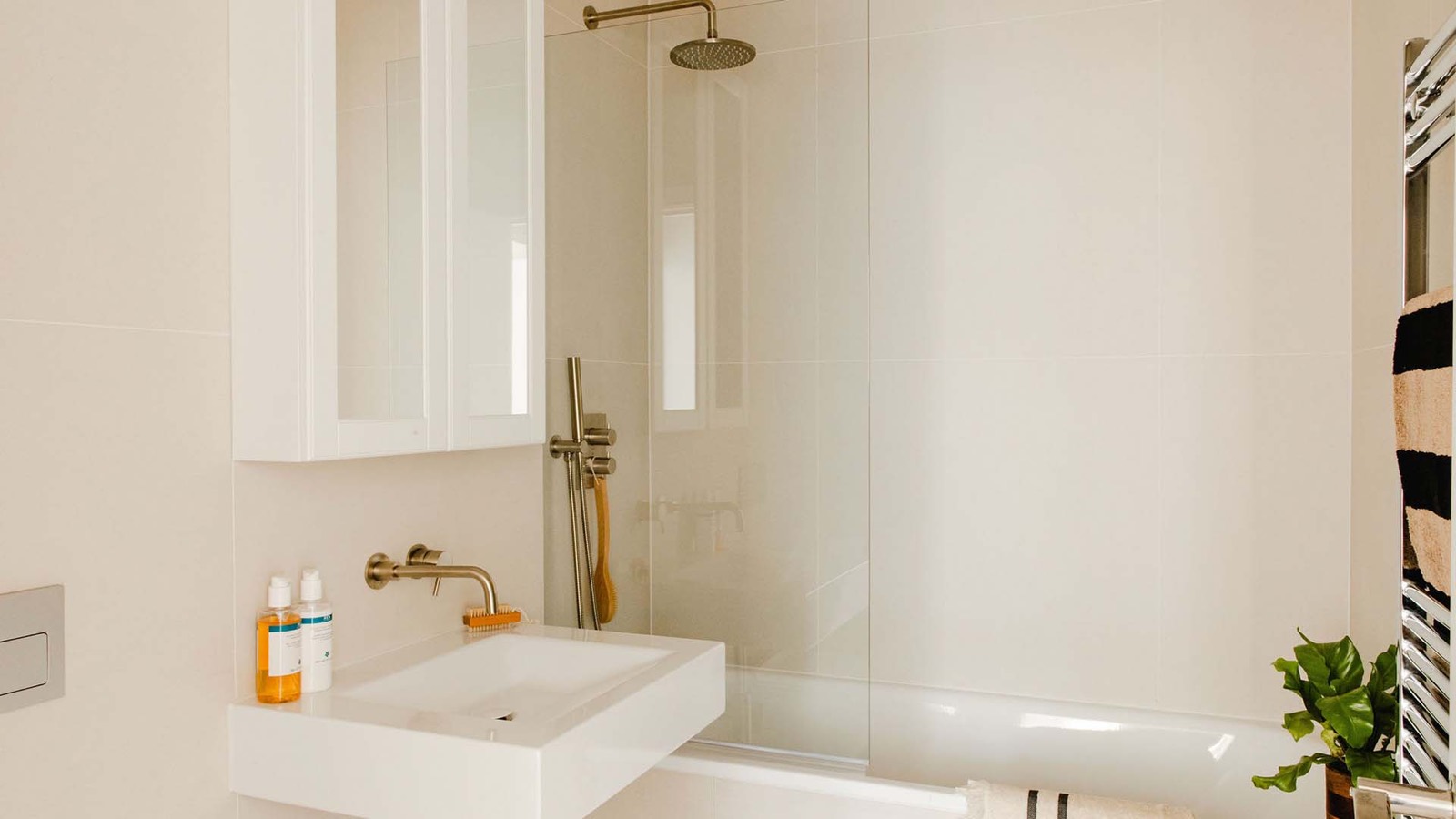 Bathroom with rain shower over the bath