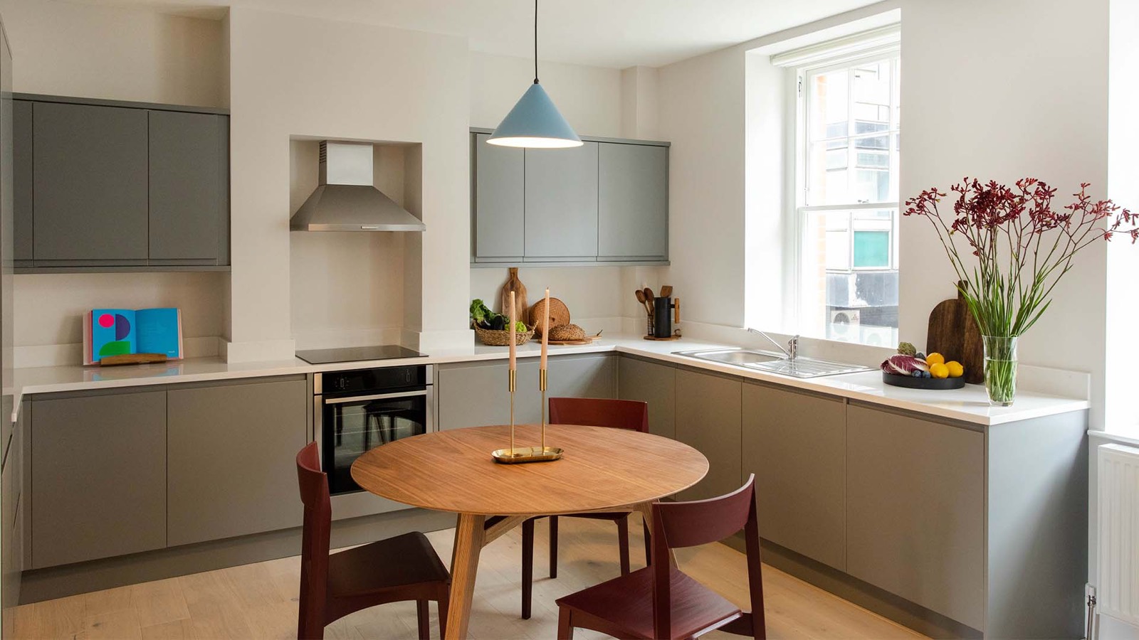 Kitchen with round dining table beneath pendant