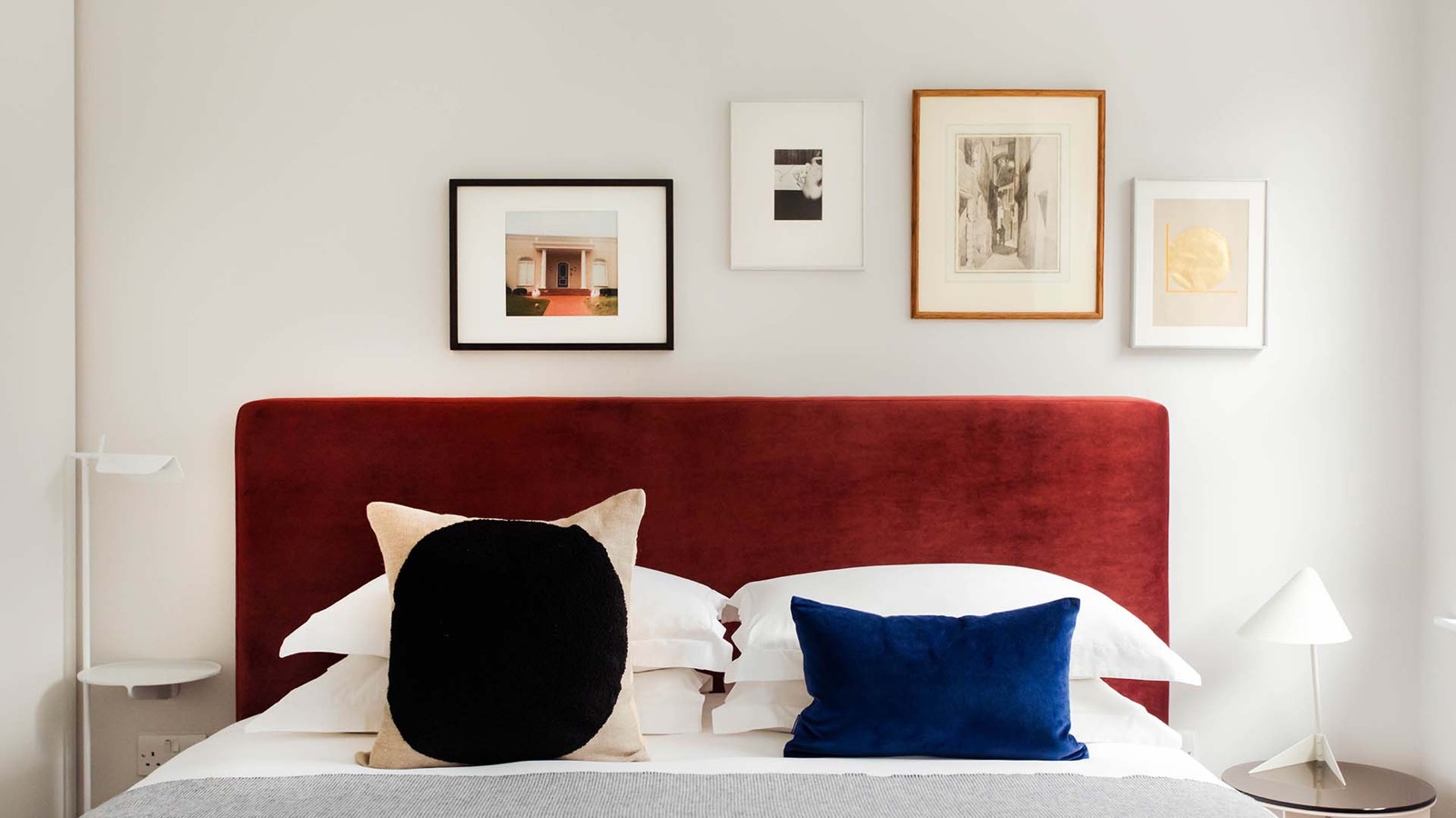 Super-king bed with red velvet headboard