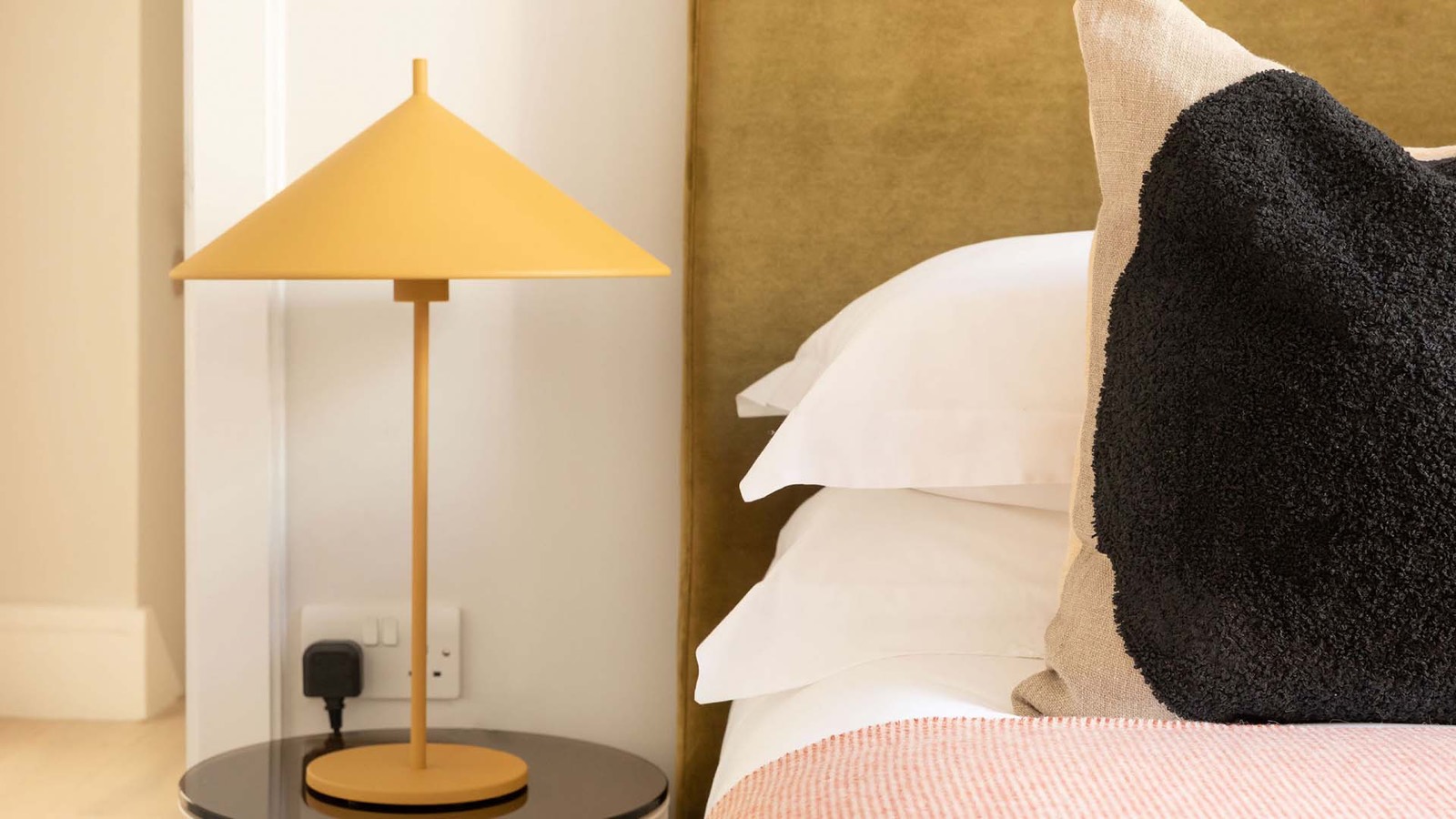 Yellow table lamp at the bedside