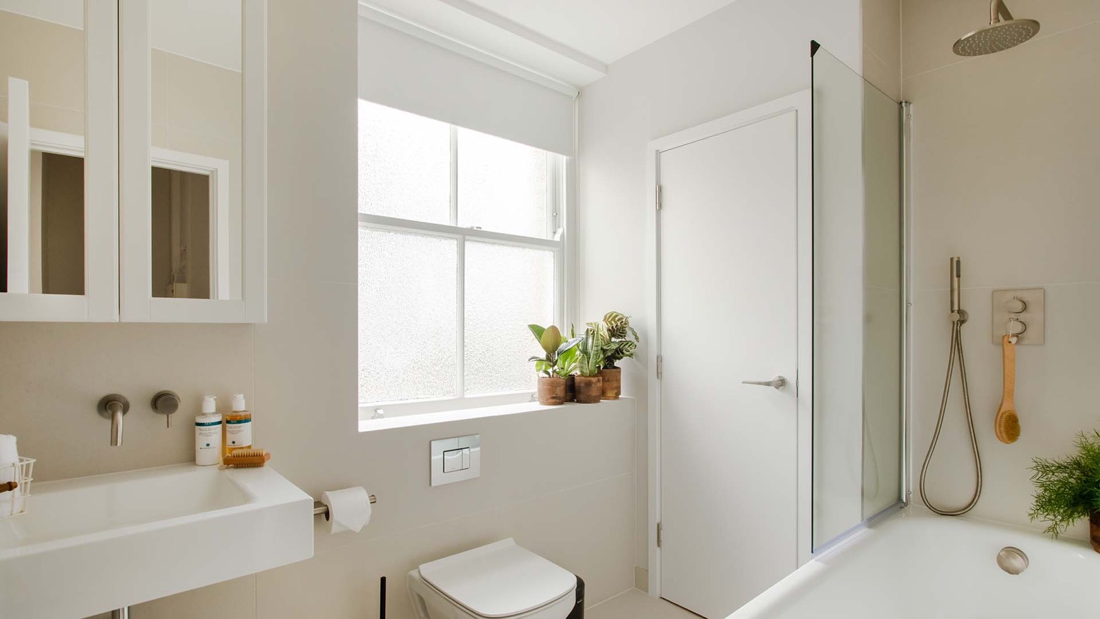 Bathroom with bathtub and rain shower