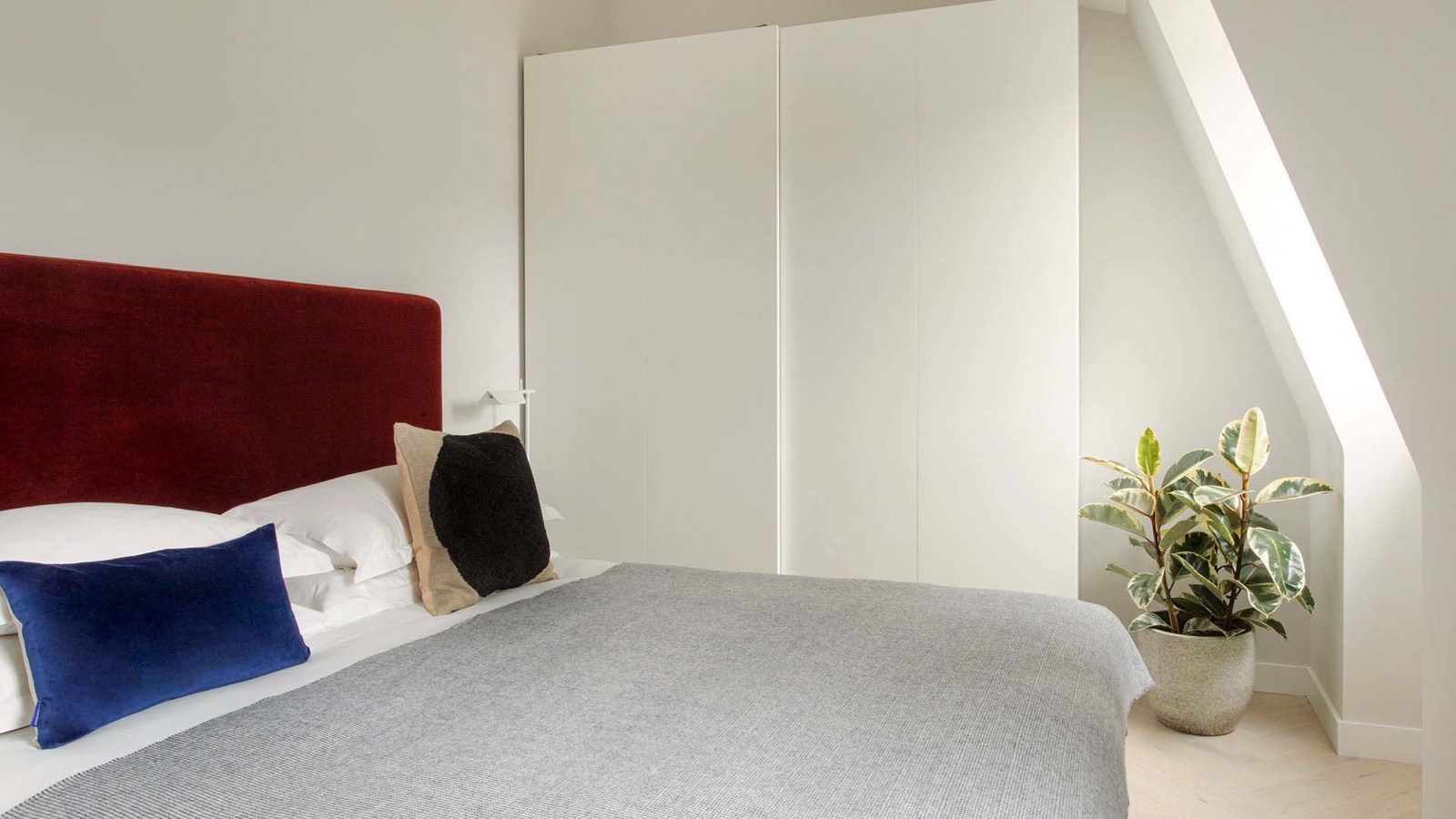 Second bedroom with red velvet headboard