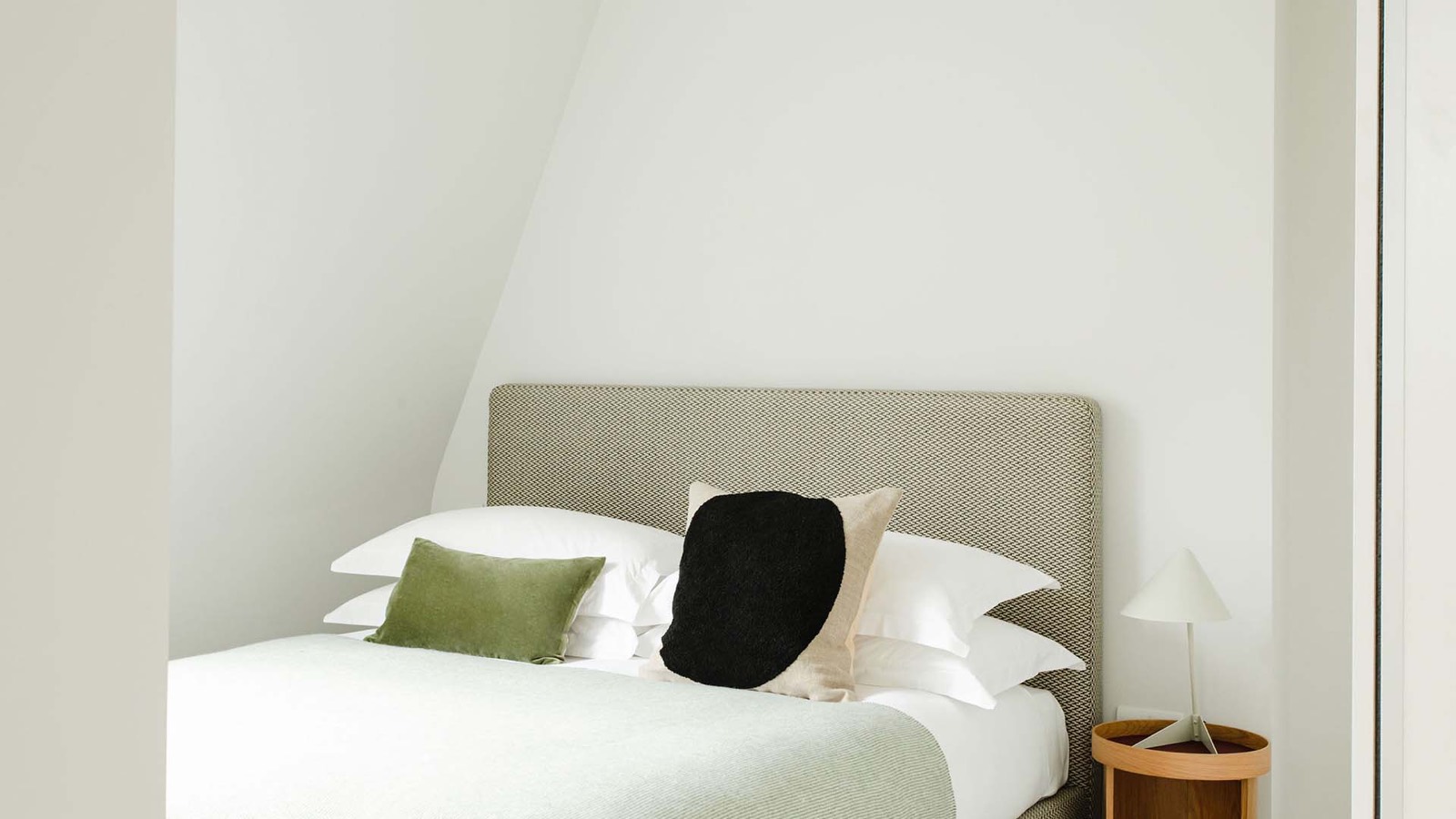 Third bedroom in soft neutrals under the eaves