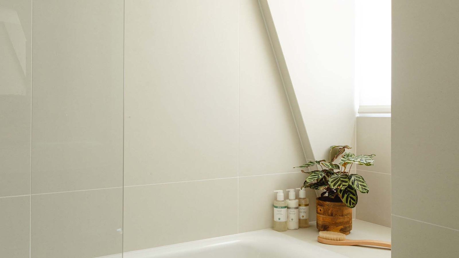 Bathtub set beneath the eaves window