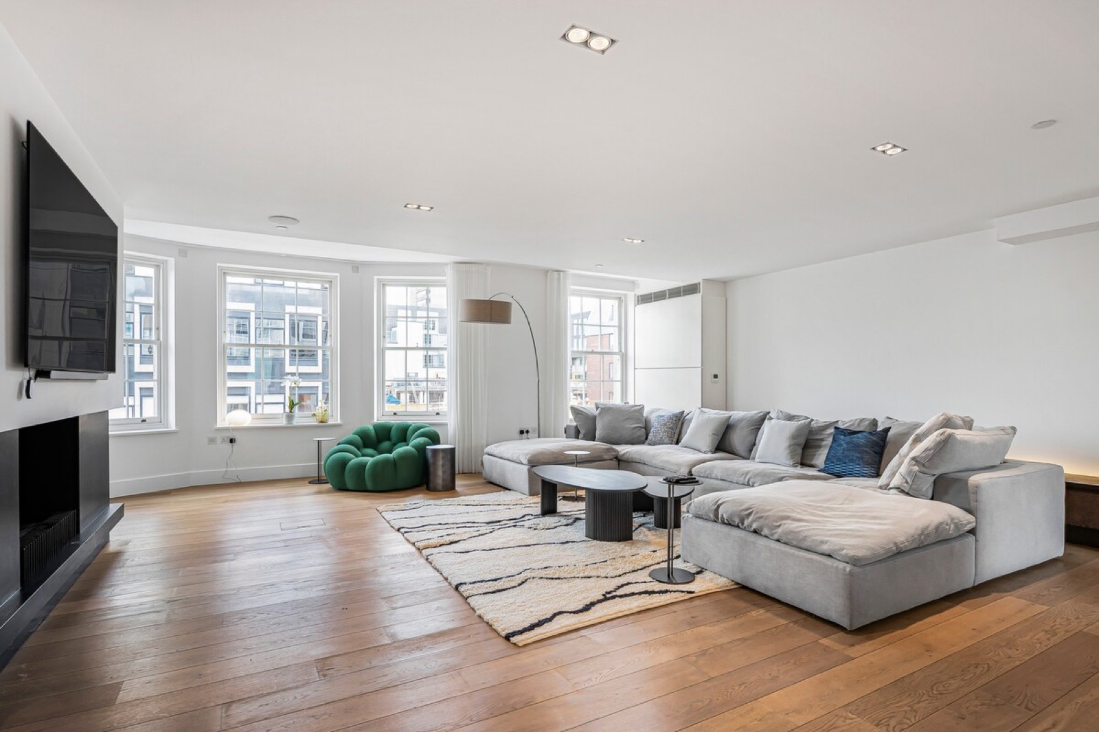 Sitting room with corner sofa and sash windows