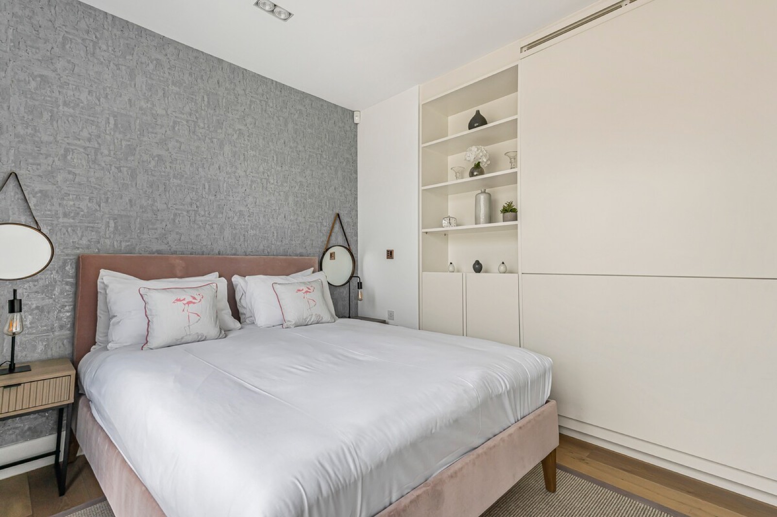 Fitted wardrobes beside the king bed
