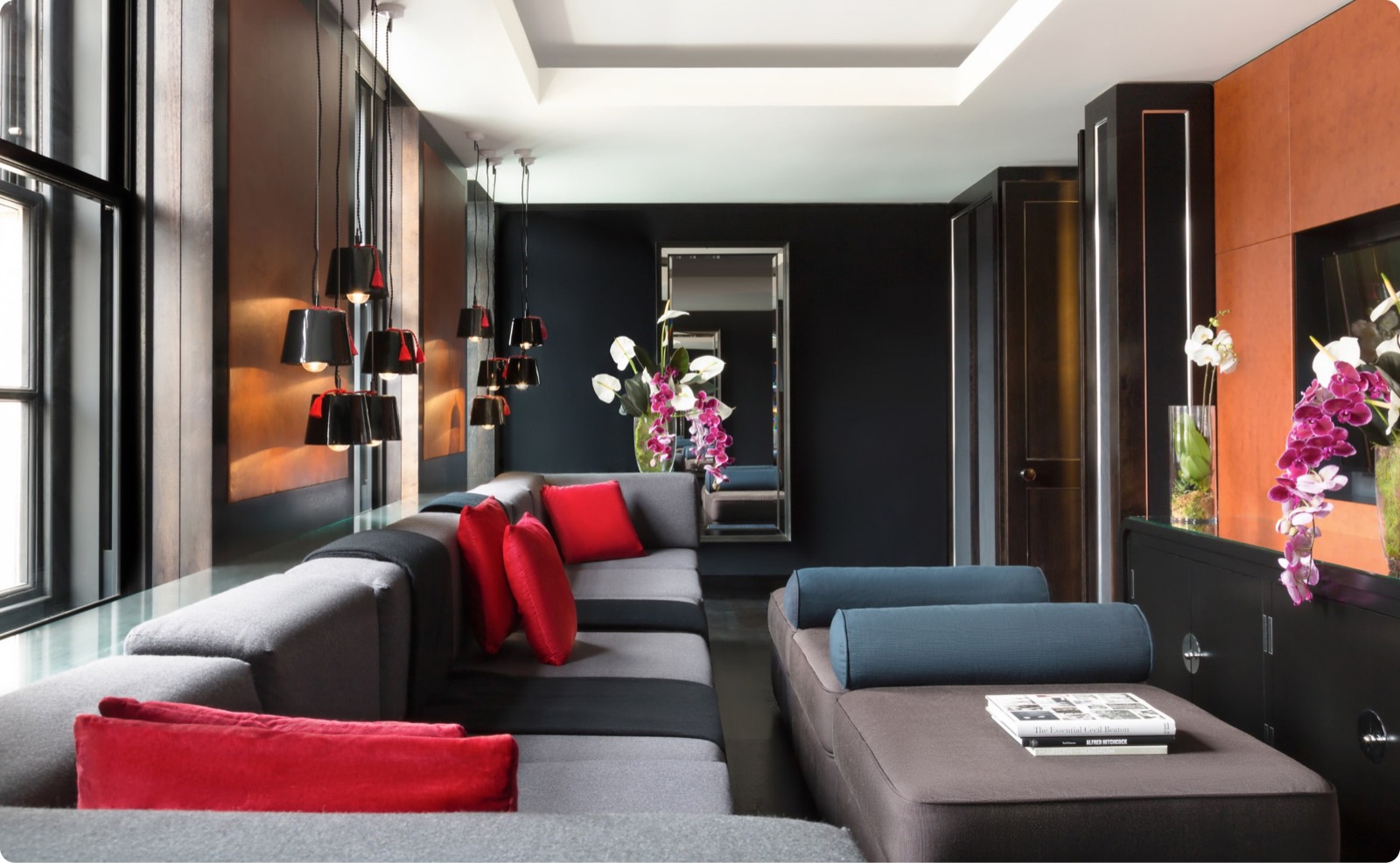 Television room with clustered pendant lamps