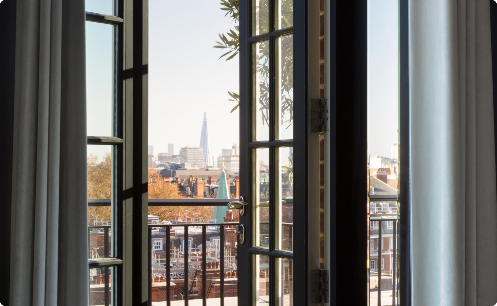 Balcony doors open over the rooftops
