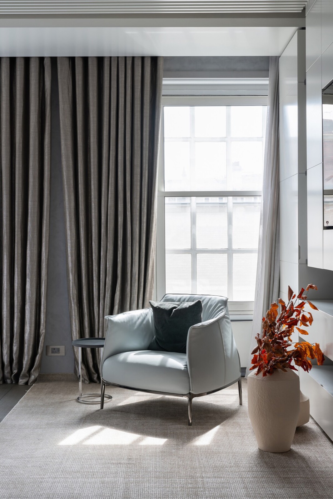 Armchair by the window, rooftops beyond