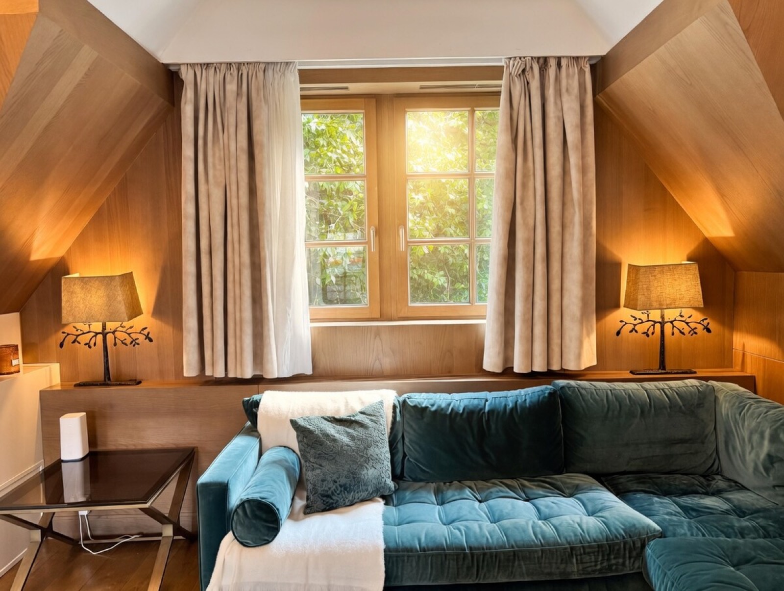 Velvet corner sofa beneath the dormer window