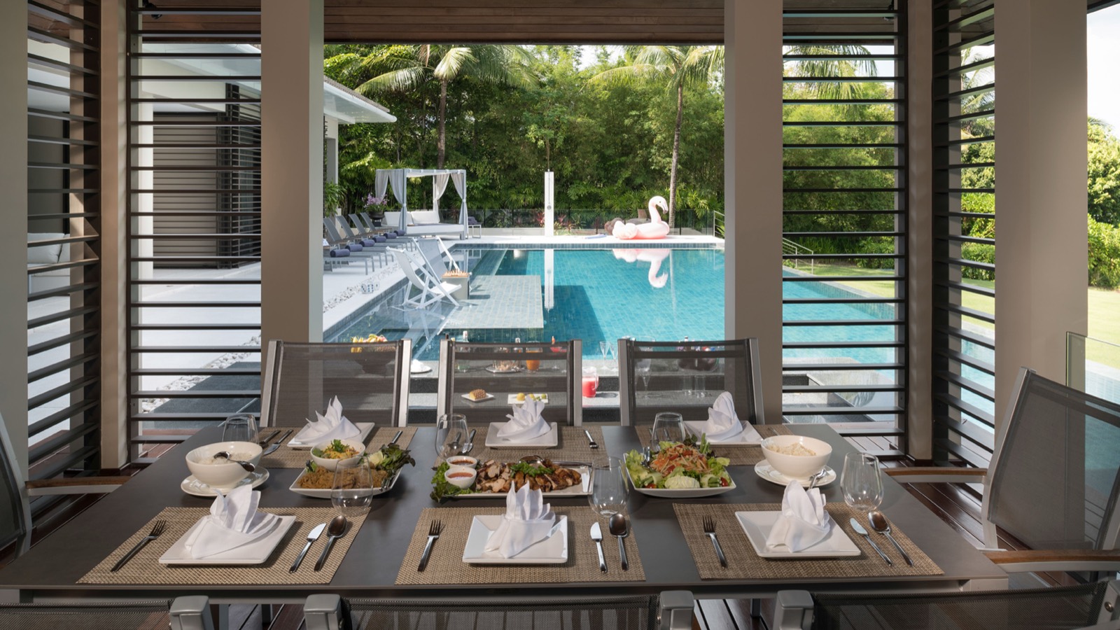 Poolside dining table laid for lunch