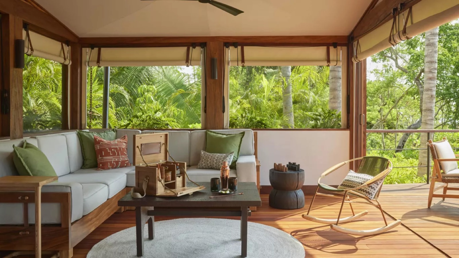 Living area with windows onto the jungle