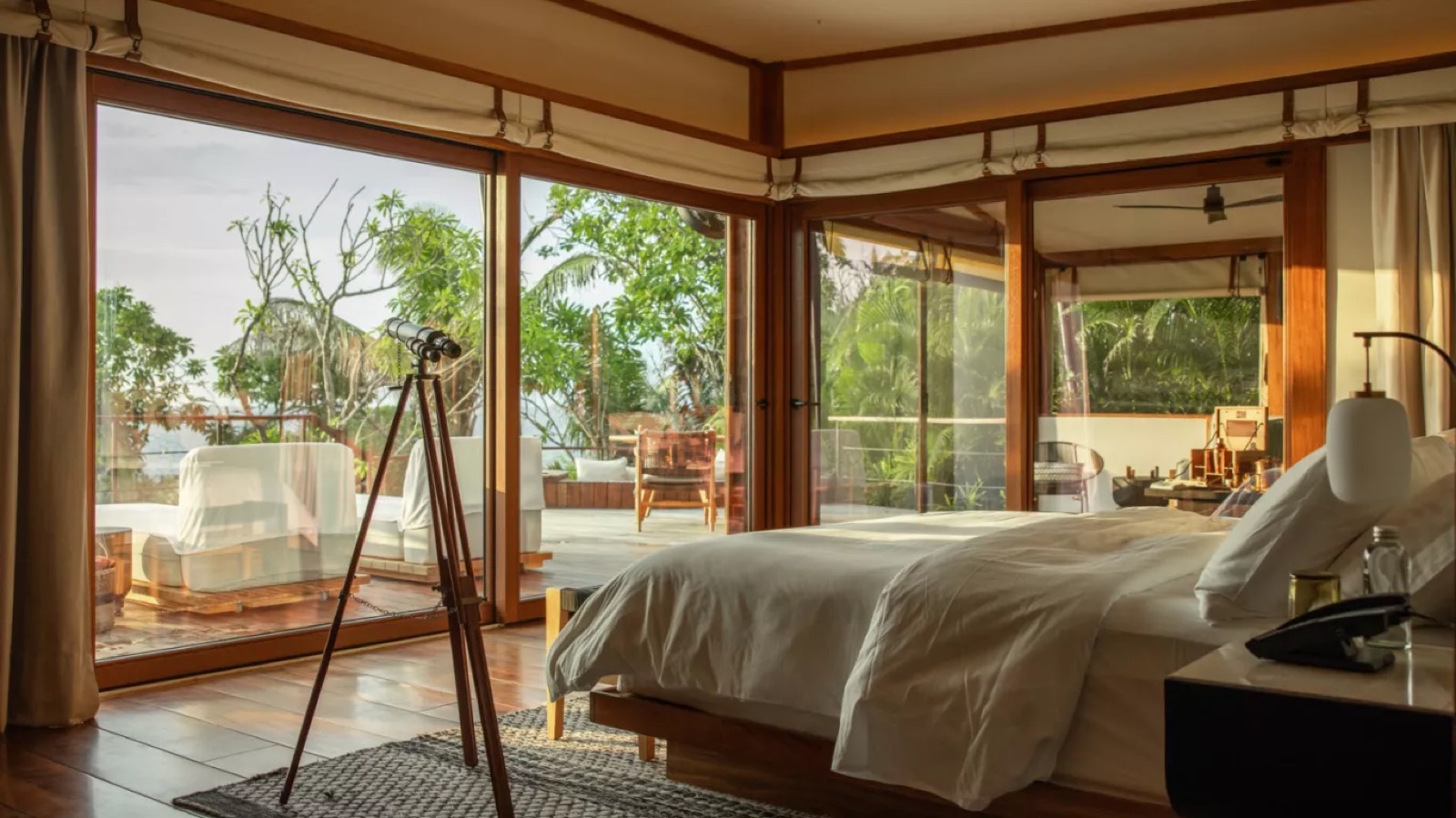 Bedroom with telescope and floor-to-ceiling glass