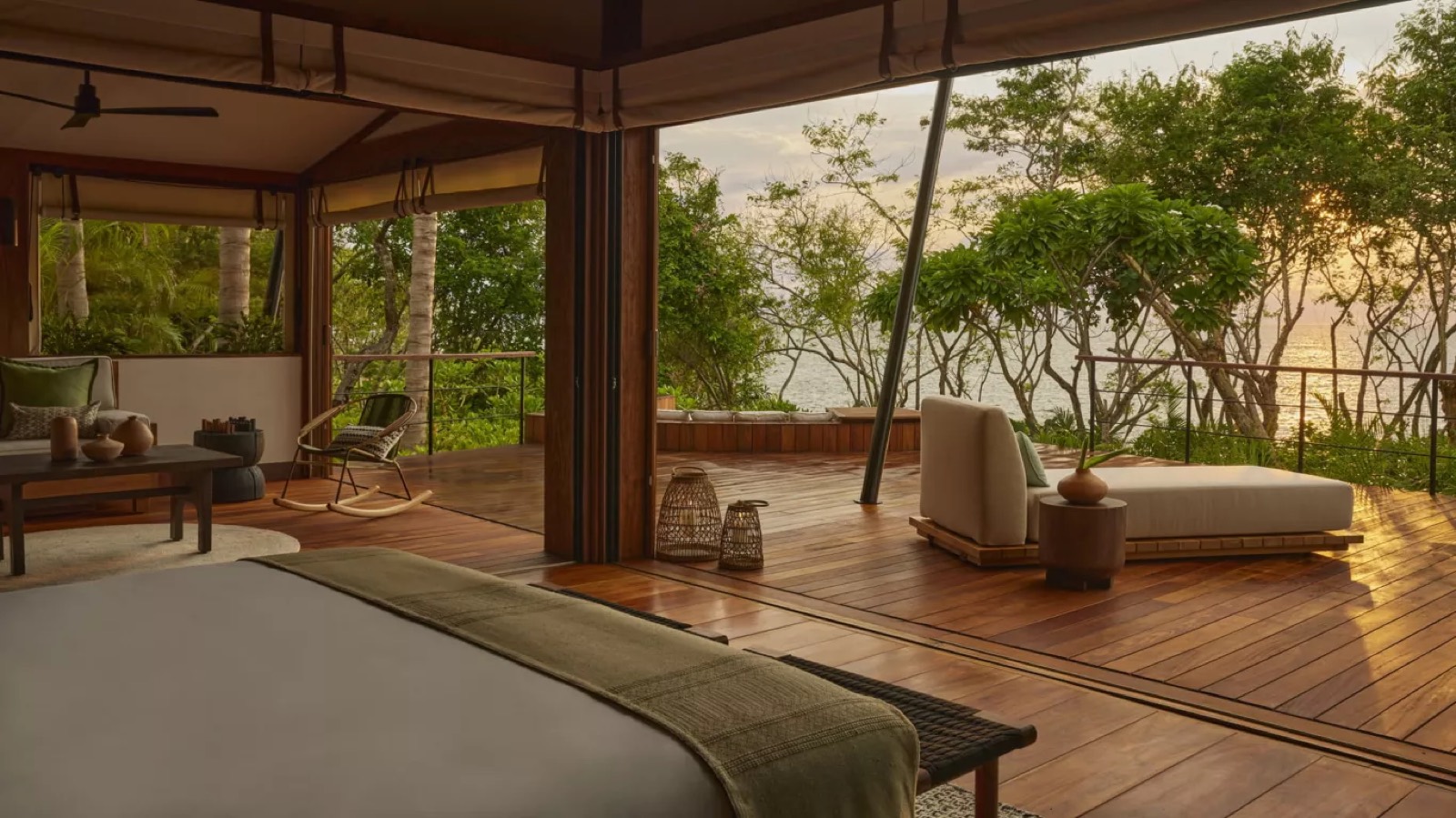 Bedroom folded open to the deck at sunset