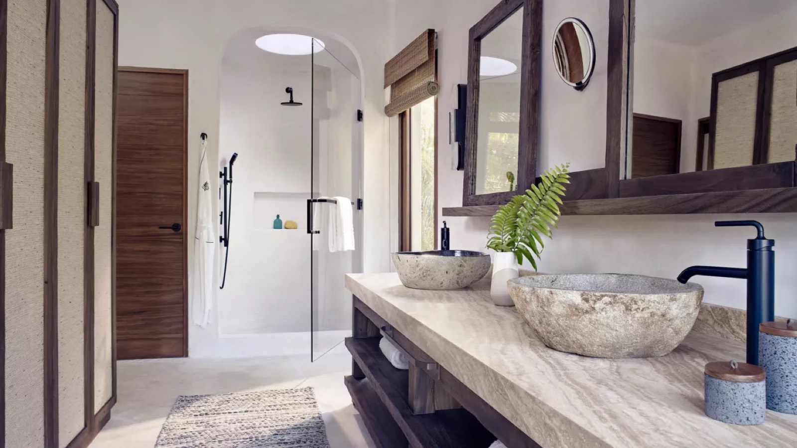 Bathroom with twin stone basins and walk-in shower