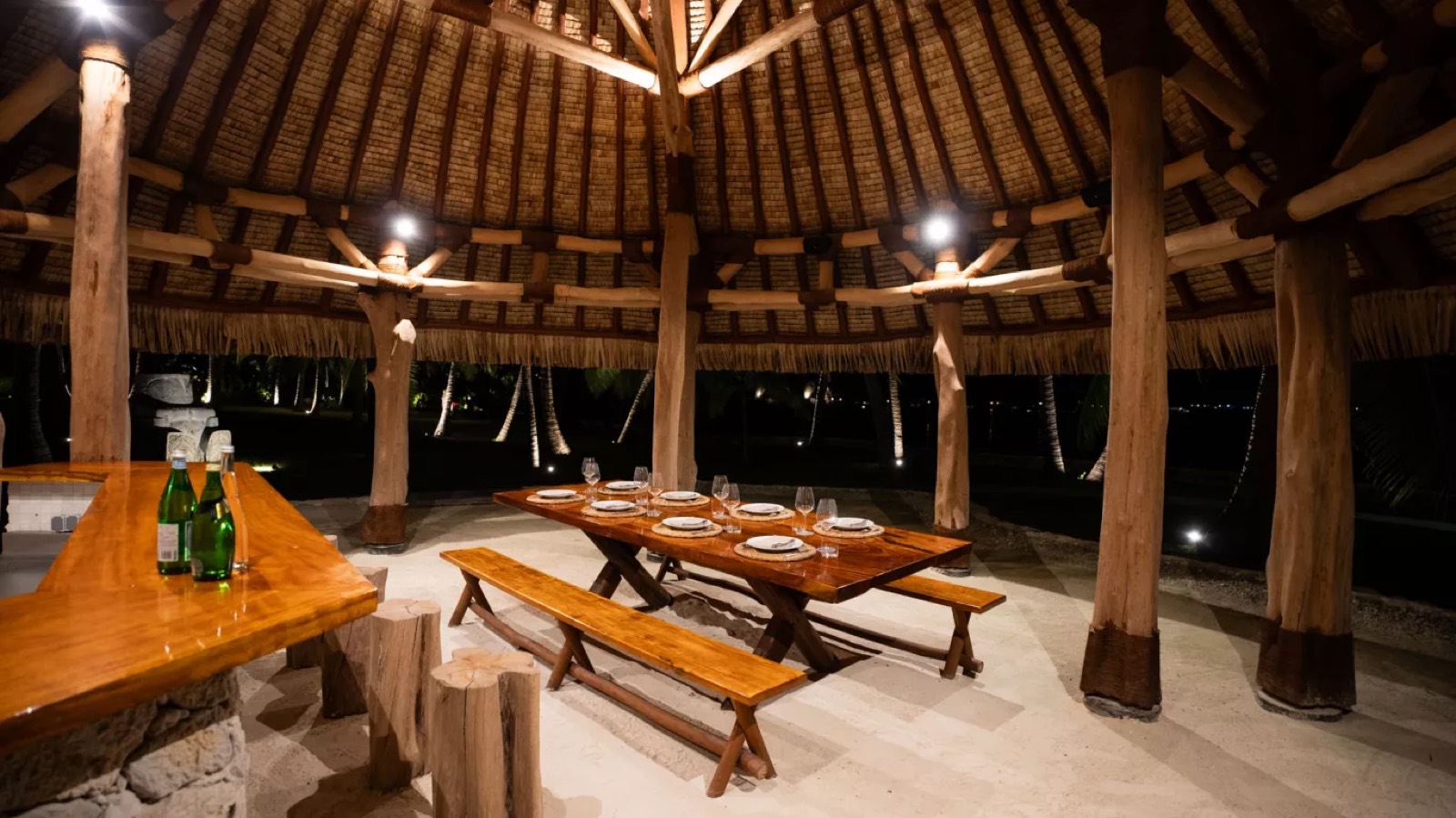 Thatched dining pavilion laid for dinner