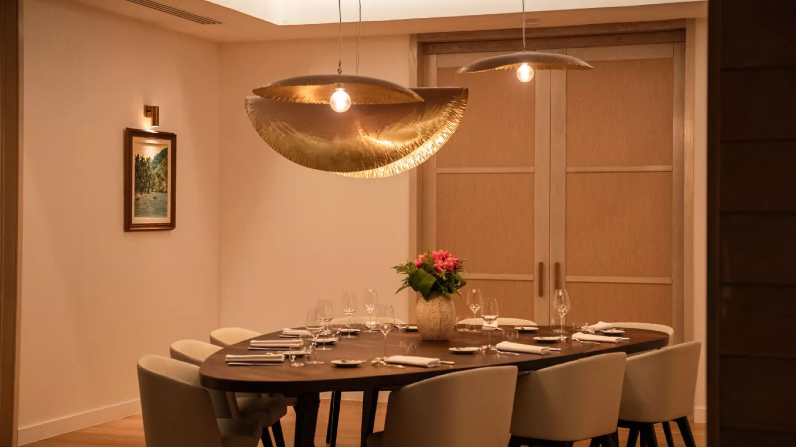 Indoor dining room beneath gilded pendants