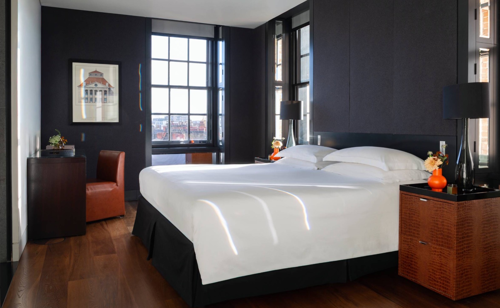 Corner bedroom with windows over the rooftops
