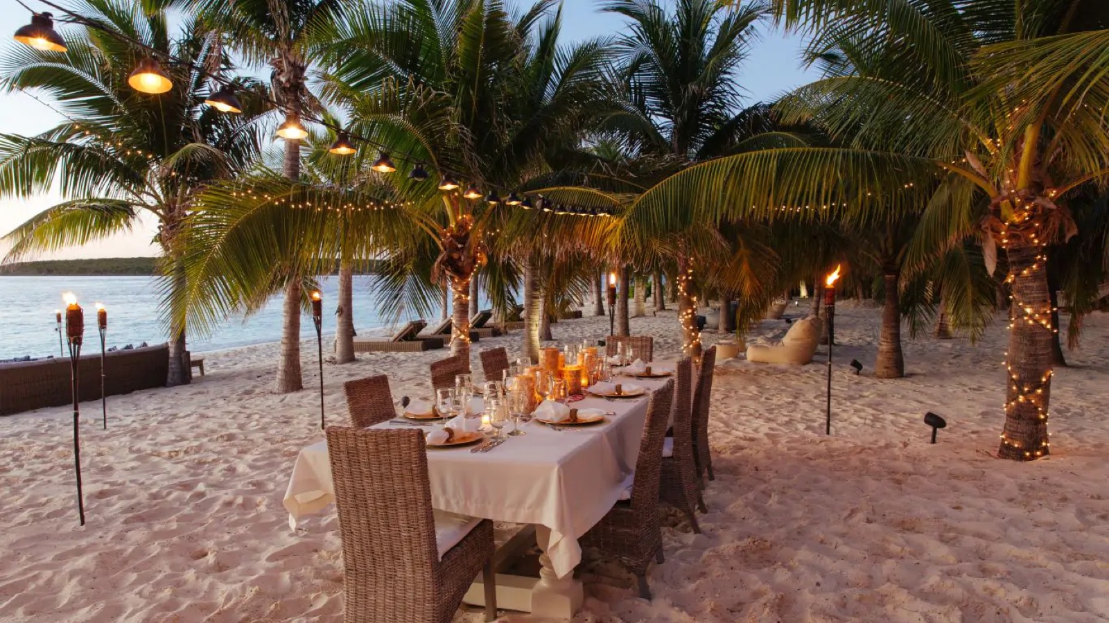 Table laid on the sand at dusk