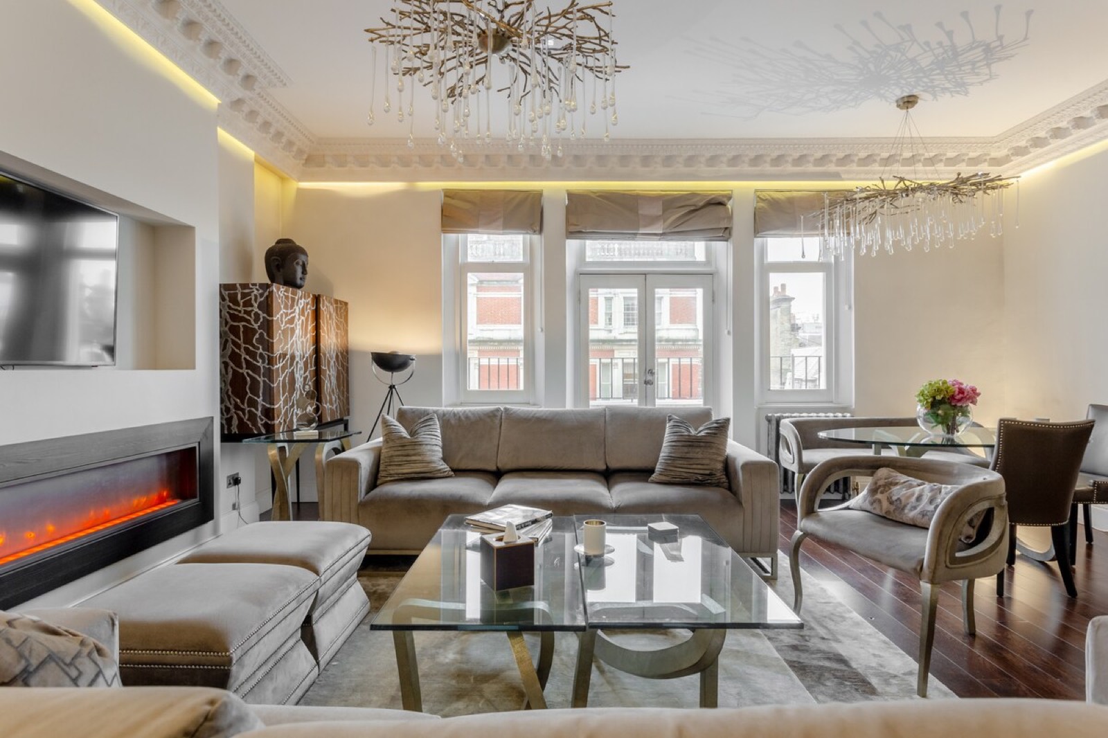 Velvet sofa below the windows and balcony doors