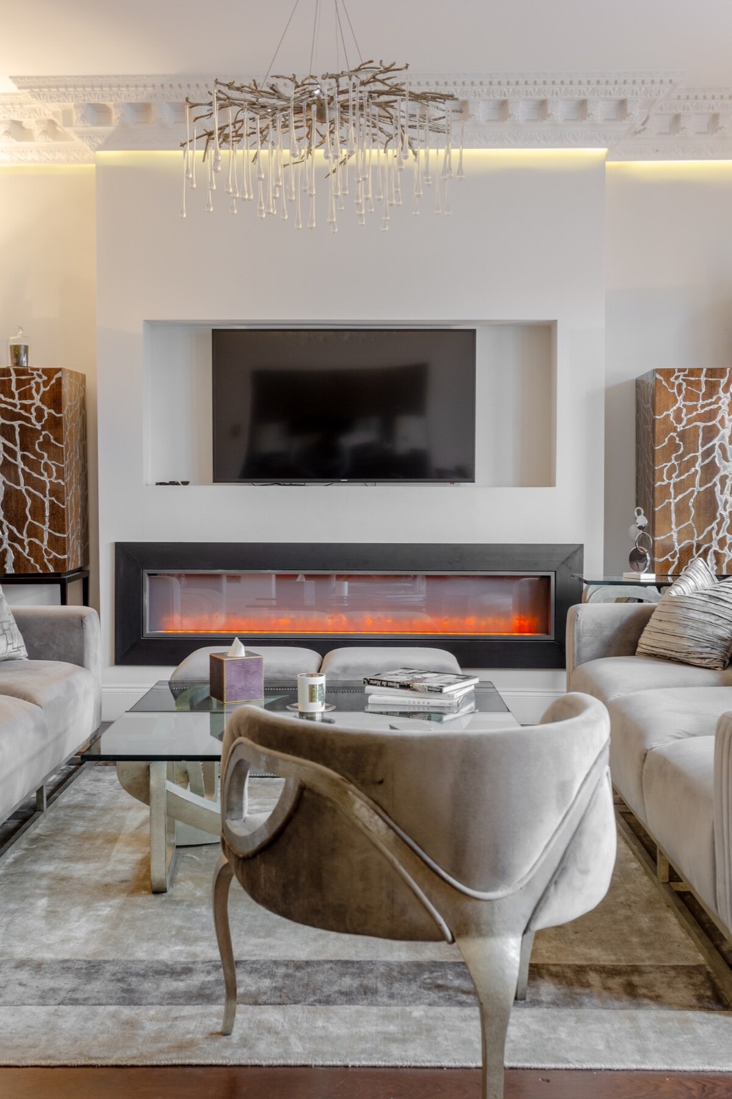 Velvet armchair drawn up to the fire