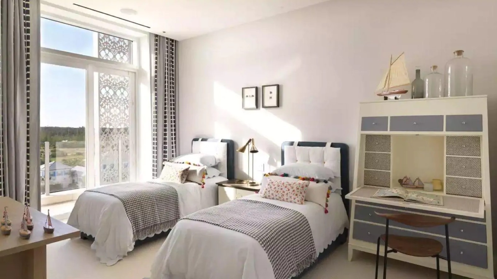 Twin bedroom with writing bureau and model boats
