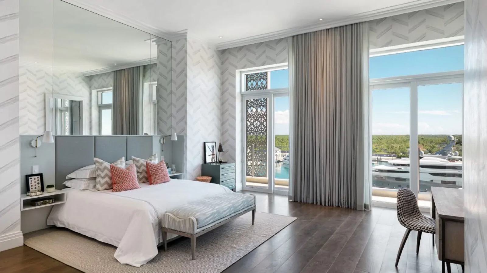 Bedroom with grey headboard and coral cushions