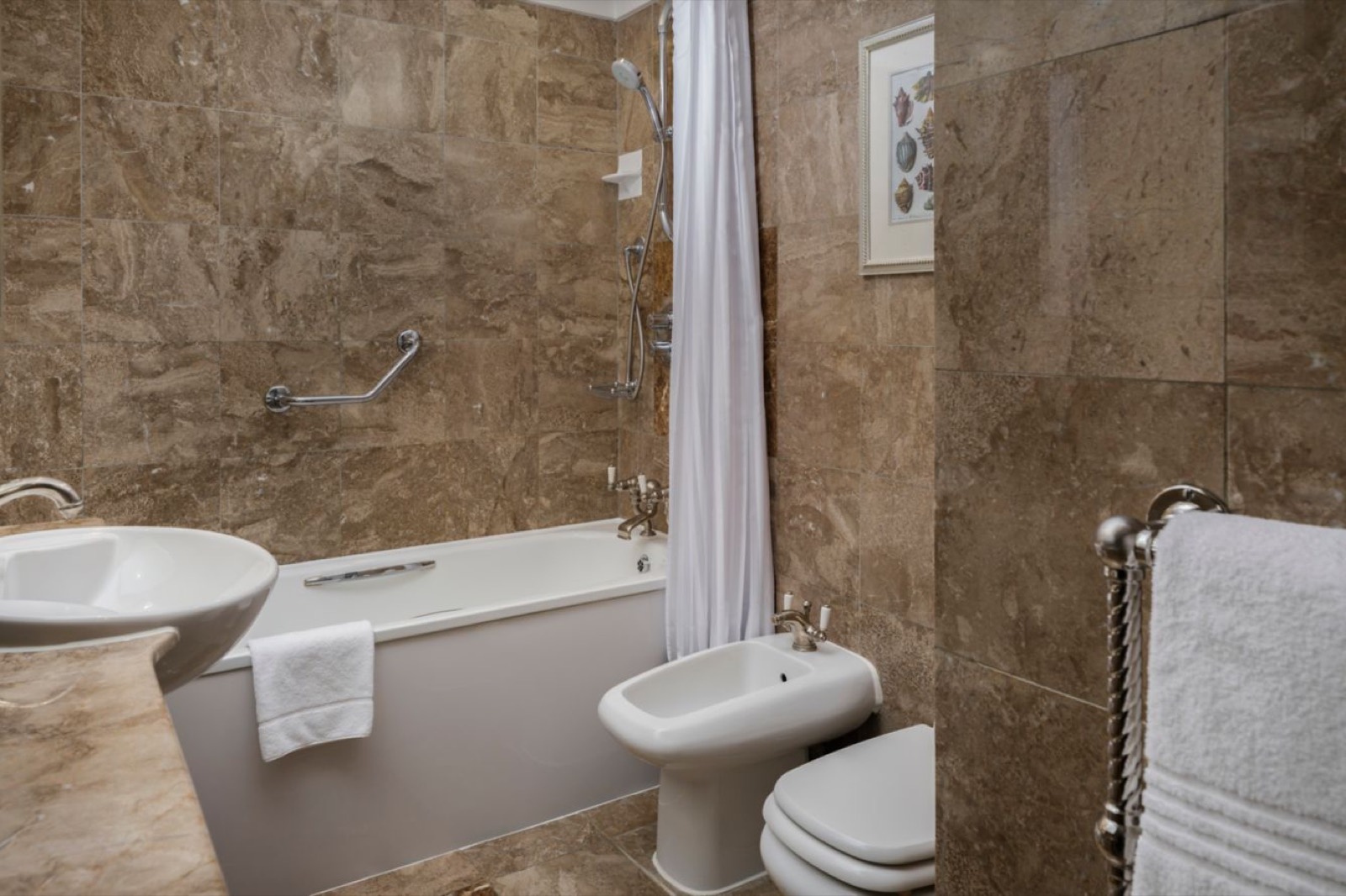 Marble bathroom with bath and towel rail