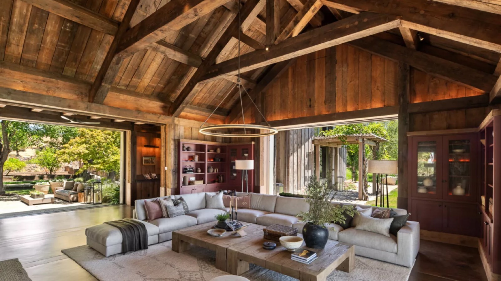 Living room under reclaimed timber trusses