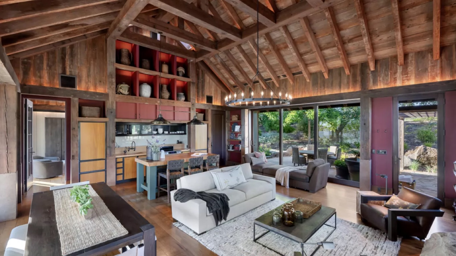 Open kitchen and sitting room with red cabinetry