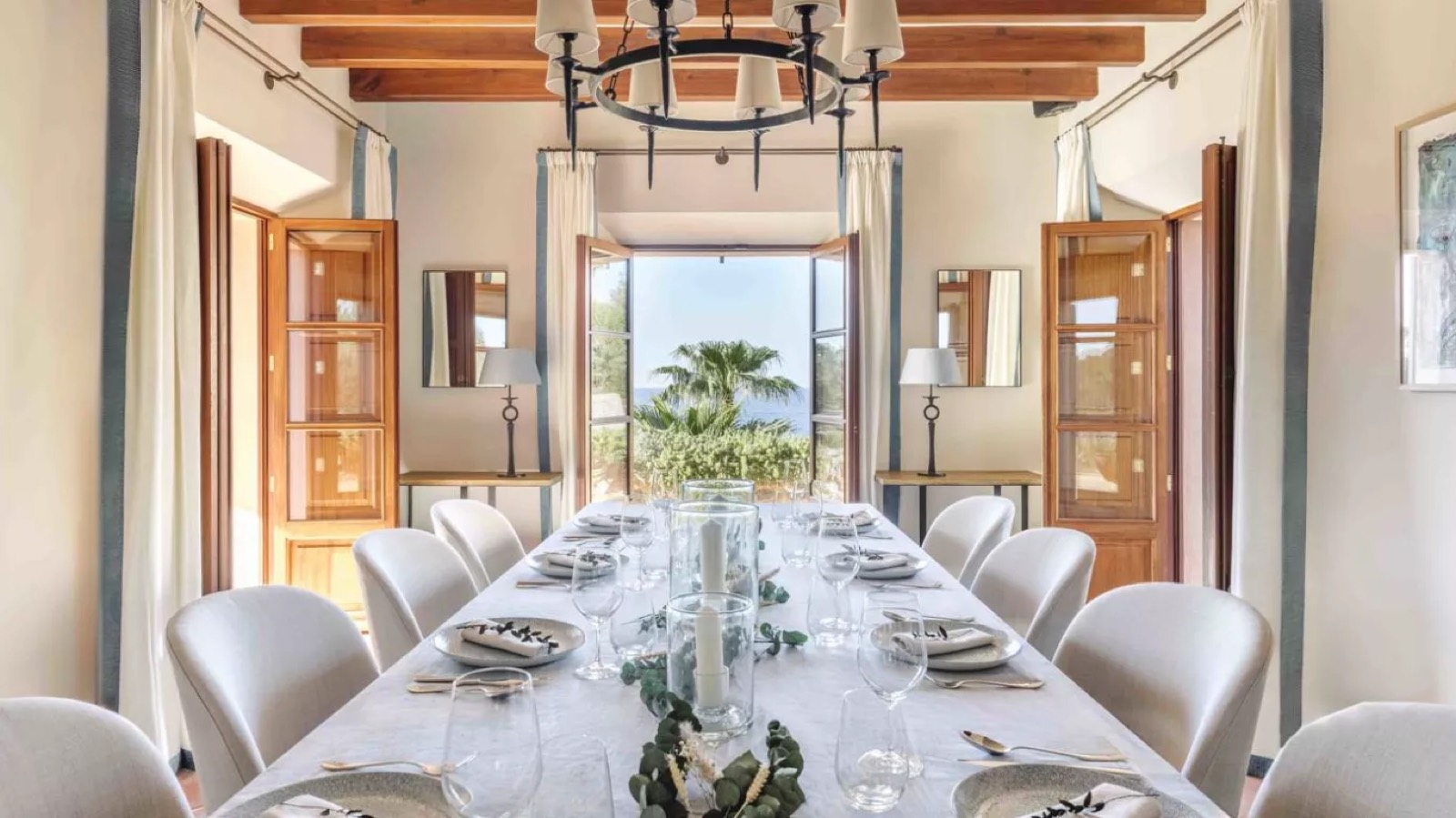 Dining table beneath the iron chandelier