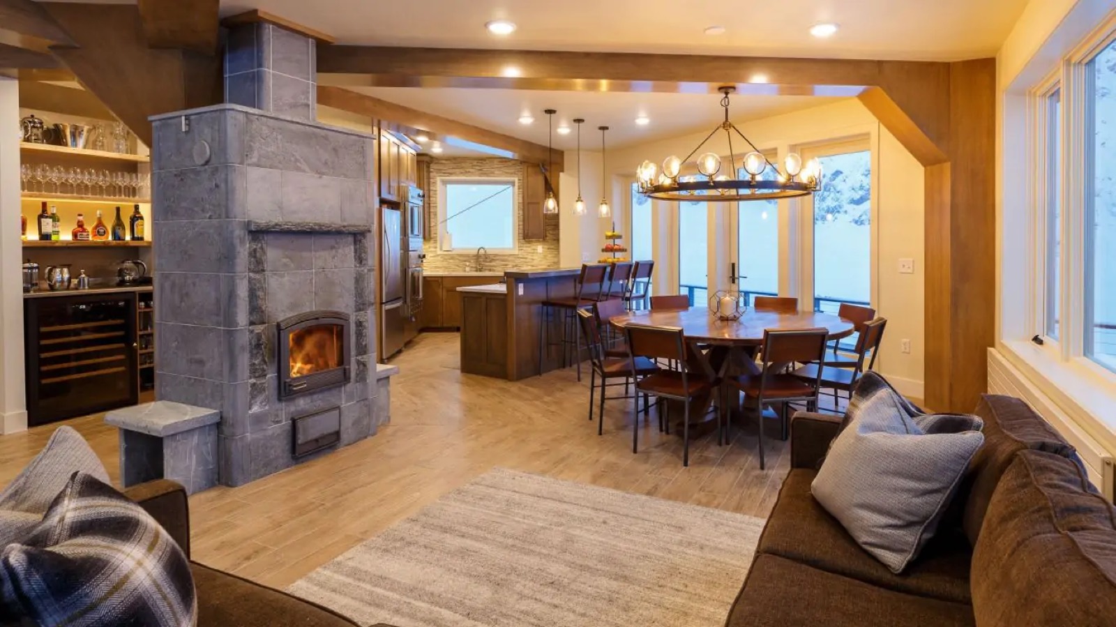 The central fireplace alight, bar and dining beyond