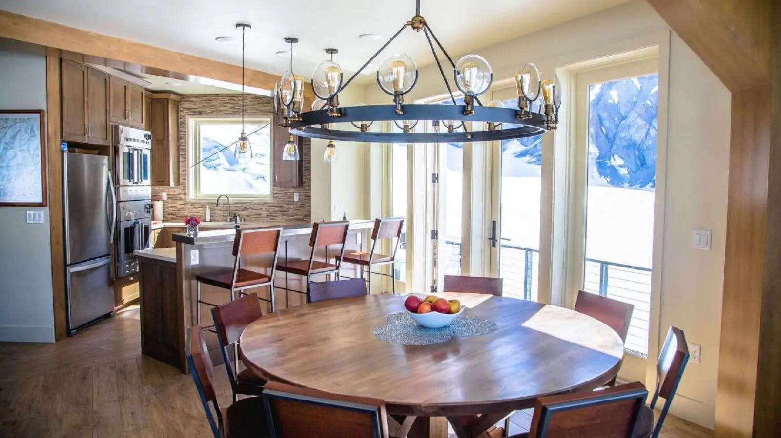 Round dining table beneath the ring chandelier