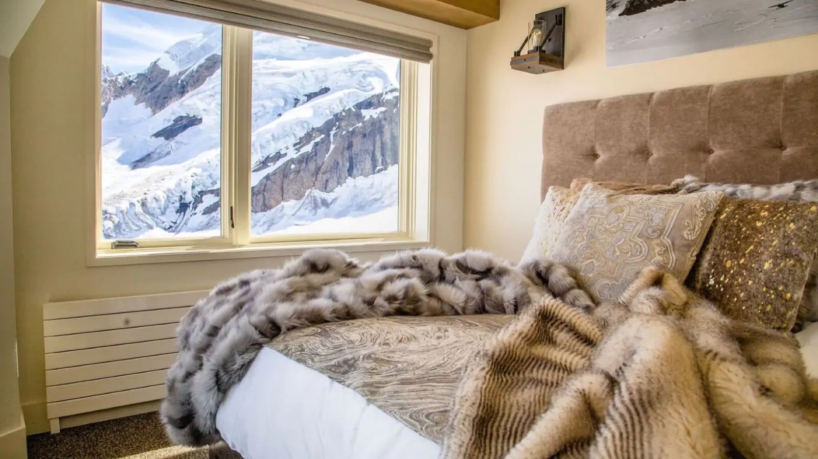 Bedroom with fur throws facing the glacier